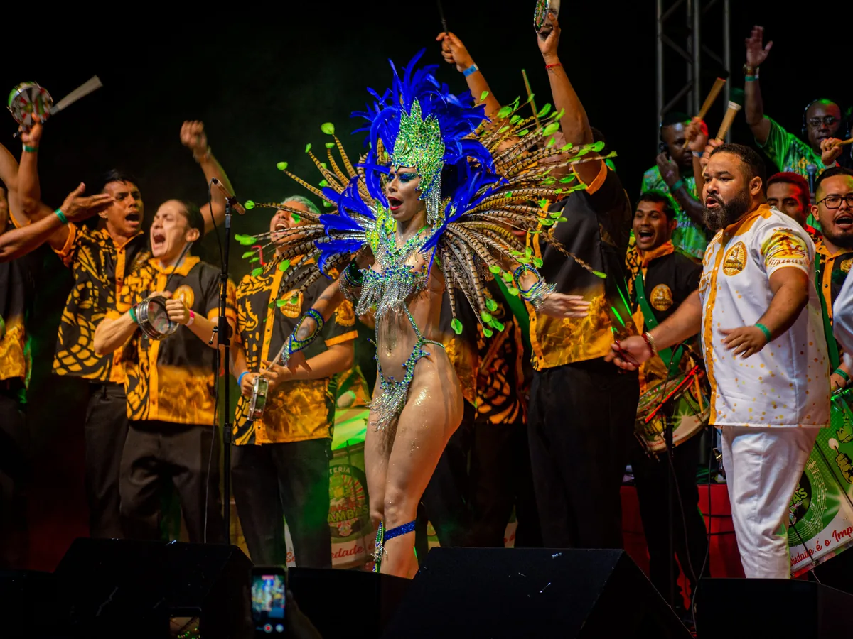 A samba bateria drum section performing in colourful costume at a Brazilian samba festival